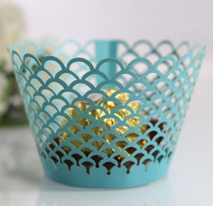 Close-up of laser-cut blue lace cupcake wrapper with fish scale hollow pattern