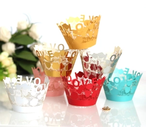 Lace laser-cut LOVE cupcake wrappers in red, gold, and silver for festive party decoration