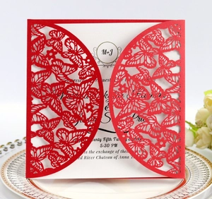 Detail of red laser-cut butterfly invitation card with elegant floral setting