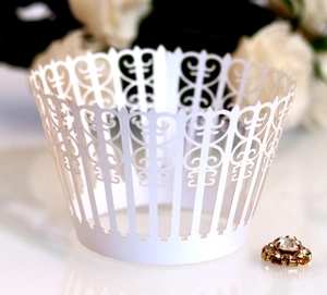 Elegant white laser-cut lace cupcake wrappers with delicate floral vine hollow patterns