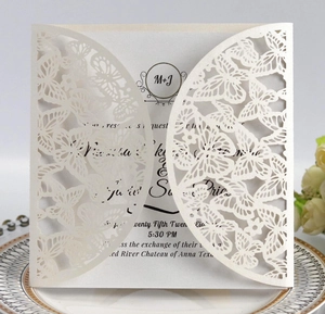 Detailed laser-cut butterfly hollow pattern on elegant pearl white wedding invitation