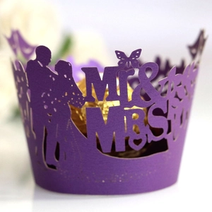 Purple laser-cut cupcake wrappers featuring Mr & Mrs design for wedding decorations