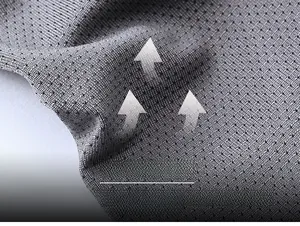 Macro shot of grey breathable mesh fabric showing the moisture-wicking pore structure