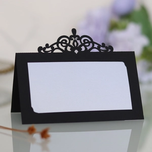 Détail macro du motif de couronne découpé au laser sur carte de table de mariage chic