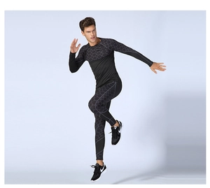 Detail of men compression suit with grey honeycomb patterns on black stretchy fabric