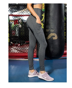 Dettaglio dei leggings da yoga grigi a vita alta con pratiche tasche laterali porta cellulare