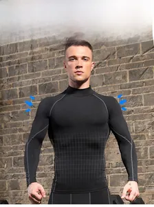 Detail of men's black thermal compression shirt with reinforced grey seams and mock neck