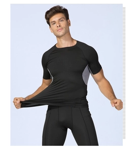 Detail of high-elastic black men's compression suit showing grey mesh side paneling