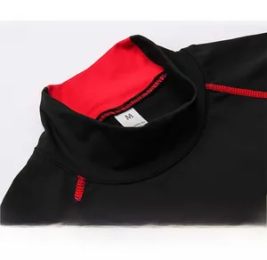 Detail of red stitching on men's thermal turtleneck compression shirt with size M label