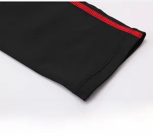 Detail shot showing contrast red stitching on black elastic sleeve of sports shirt