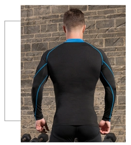 Rear view of men's compression shirt with blue stitching in a gym setting