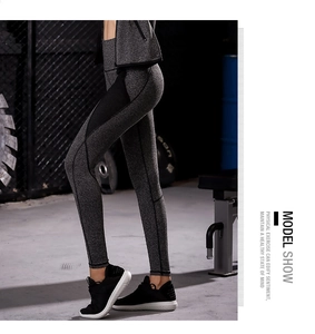 Detail view of women's gray marl gym leggings with black mesh side panel insert