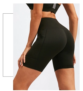 Detail of high-waisted yoga shorts featuring a side pocket and moisture-wicking fabric