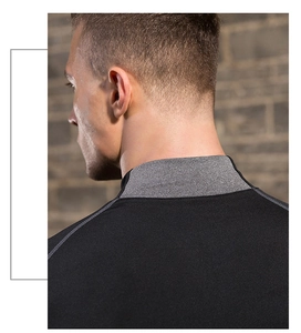 Detail of flatlock shoulder seams and high neck on a slim-fit athletic compression shirt