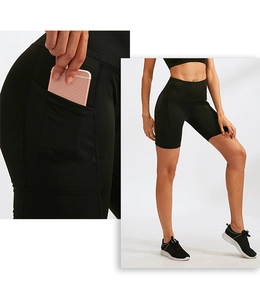 Detail of high waist yoga shorts with side pocket for phone and elastic fabric texture