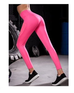 Close-up of high-waist pink yoga leggings showing stretch fit and lifting effect