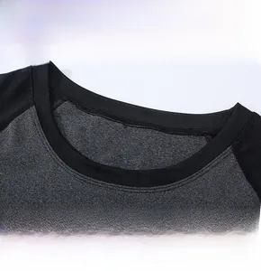 Close-up of comfortable round neck and raglan sleeve stitching on charcoal yoga top