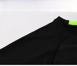 Detail of men's quick-dry sports shirt neck with green mesh lining and raglan sleeve stitching