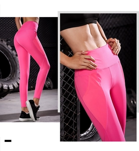 Macro view of high-waist yoga pants featuring mesh side panels and reinforced seams