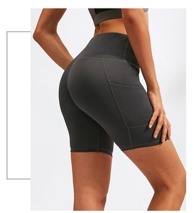 Close-up of high-waisted yoga shorts with functional side pockets in dark gray