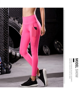 Detail of rose pink yoga leggings featuring functional side mesh pockets for phone storage