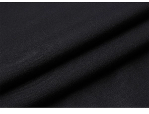 Close-up of black breathable knit fabric showing texture and soft folds of gym shirt