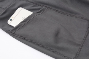 Detail of high-waisted yoga shorts with functional side pocket for phone storage