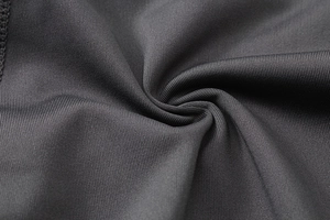 Macro shot of charcoal grey high-stretch yoga shorts fabric with soft ribbed texture
