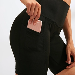 High waist yoga shorts with side pockets for running and training in black stretch fabric