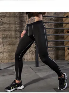 Detail view of men's athletic compression leggings with grey contrast stitching