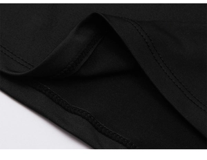 Close-up of double-stitched hem on black athletic compression shirt showing fabric texture