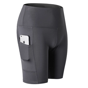 Women's high waist grey yoga shorts with side pocket showing phone storage feature