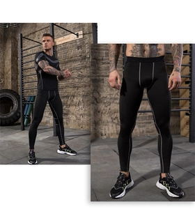 Close-up of flatlock seams on men's quick-dry compression pants with reflective details