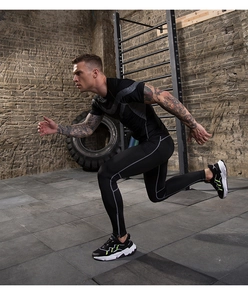 Close-up of men's black athletic compression suit with grey geometric tech patterns
