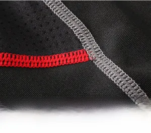 Close-up of sports shirt with breathable mesh fabric and contrast grey and red stitching