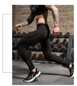 Close-up of men's athletic compression pants featuring a side ankle zipper for easy wear