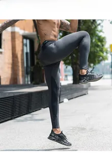 Detail of men's Pro compression pants showing elastic waist and ergonomic stretch fit