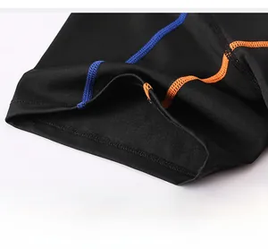 Close-up of breathable mesh fabric with blue and orange reinforced stitching on sports tee