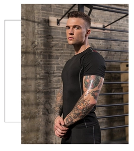 Side view of men's black compression gym shirt showing flatlock seams and muscle fit