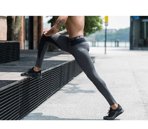 Close-up of men's compression pants with YEL PRO elastic waistband and mesh panels