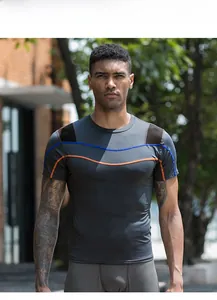 Close-up of men's compression shirt with reflective wave patterns and quick-dry fabric