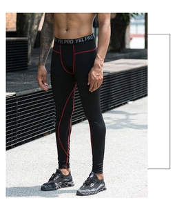 Detail of men's compression pants with red ergonomic stitching and elastic waistband