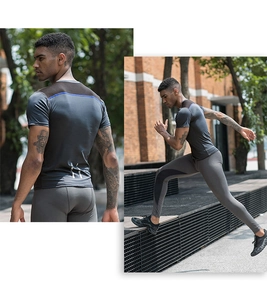 Detailed view of dark grey compression sport set with reflective strips and breathable fabric