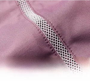 Close-up of purple athletic jacket featuring white mesh panels and double-stitched seams