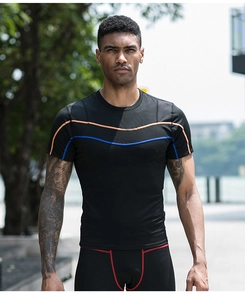 Detail of high-stretch compression shirt with orange and blue reflective stitching for men