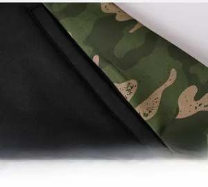 Detail shot of men's athletic hoodie featuring camouflage patchwork and premium stitching