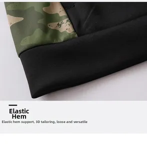 Detail shot of the camouflage hoodie showing the elastic ribbed hem and premium stitching