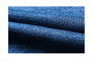 Macro shot of breathable blue mesh fabric with micro-pores for quick-dry athletic performance