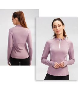 Detail of slim-fit athletic long sleeve top with stand collar and half-zip for women