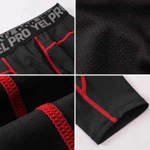 Detail of men's pro gym leggings showing red stitching and breathable mesh fabric